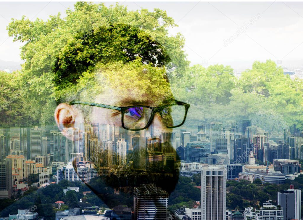 double exposure of businessman head  skyscrapers and trees  escape from the city to nature