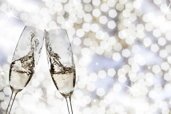 Toasting with champagne glasses on sparkling holiday background — Stock Photo, Image