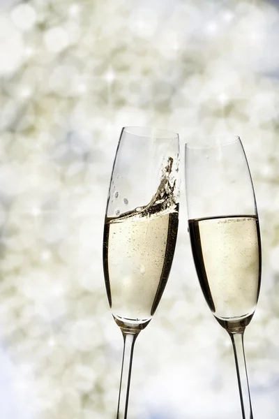 Toasting with champagne glasses on sparkling holiday background — Stock Photo, Image