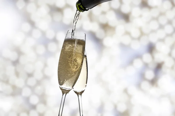 Toasting with champagne glasses on sparkling holiday background — Stock Photo, Image