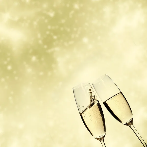 Toasting with champagne glasses on sparkling holiday background — Stock Photo, Image