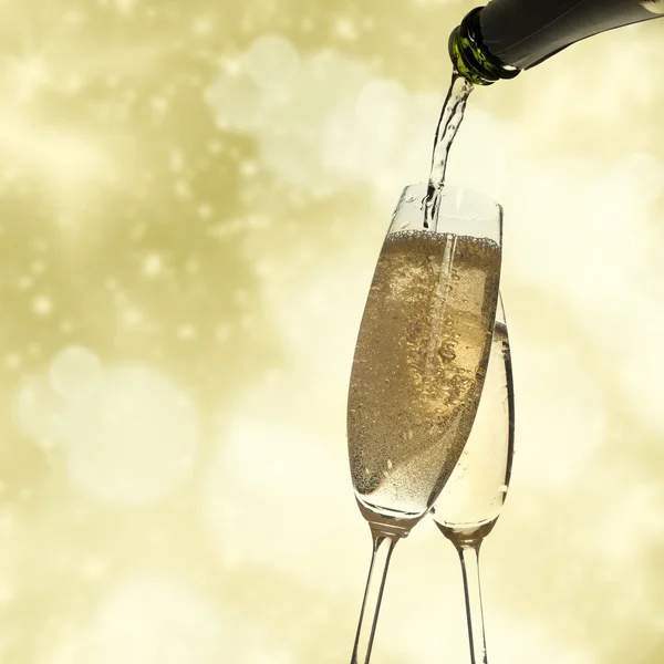 Тост с бокалами шампанского на сверкающем фоне праздника — стоковое фото