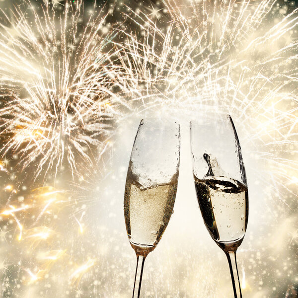 Toasting with champagne glasses on sparkling holiday background