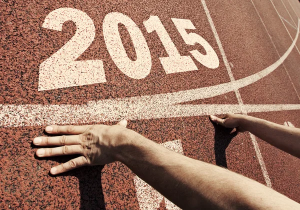 Happy new year 2015 - hands on starting line — Stock Photo, Image