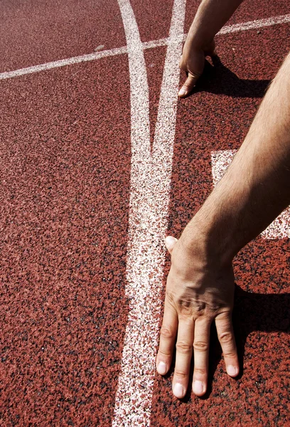 Hands on starting line — Stock Photo, Image