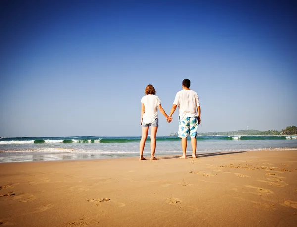 Paret tittar på havet på tropical beach — Stockfoto