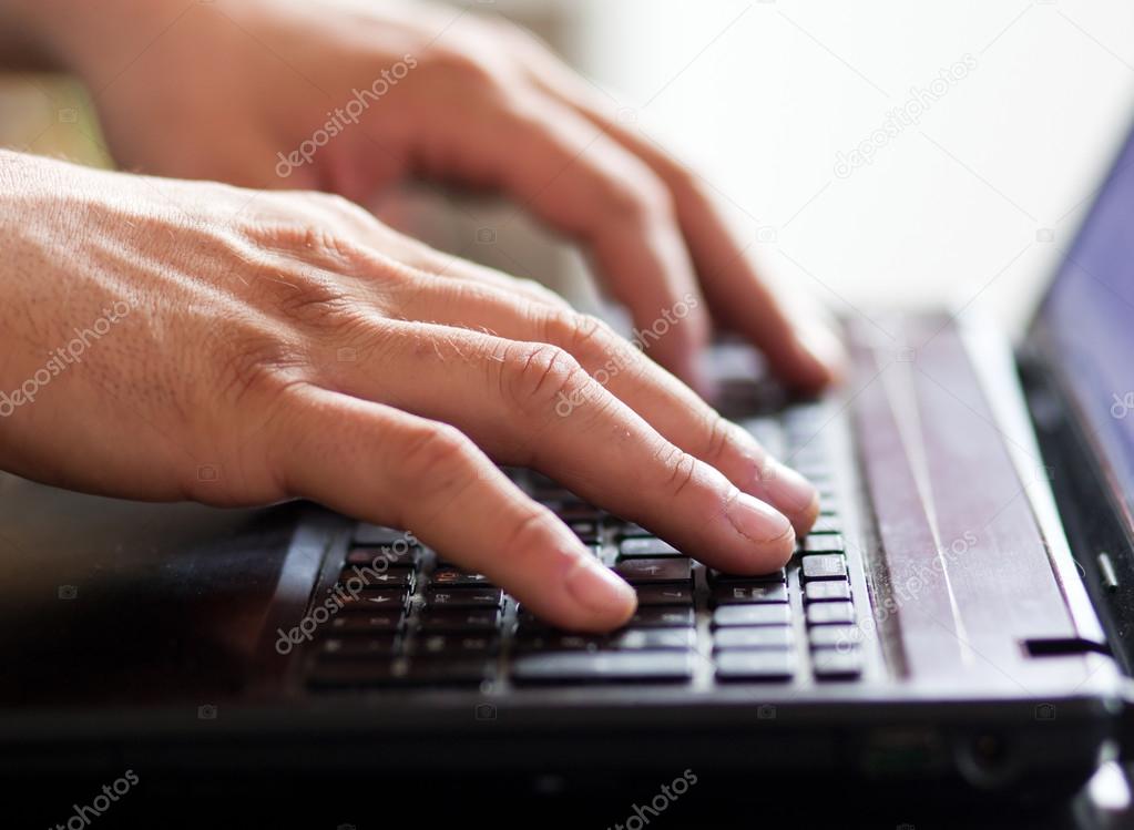 close up hands multitasking man using laptop