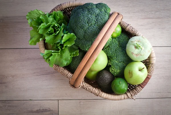 Green fruits and vegetables in basket