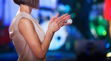 Woman clapping - stage in the background clipart