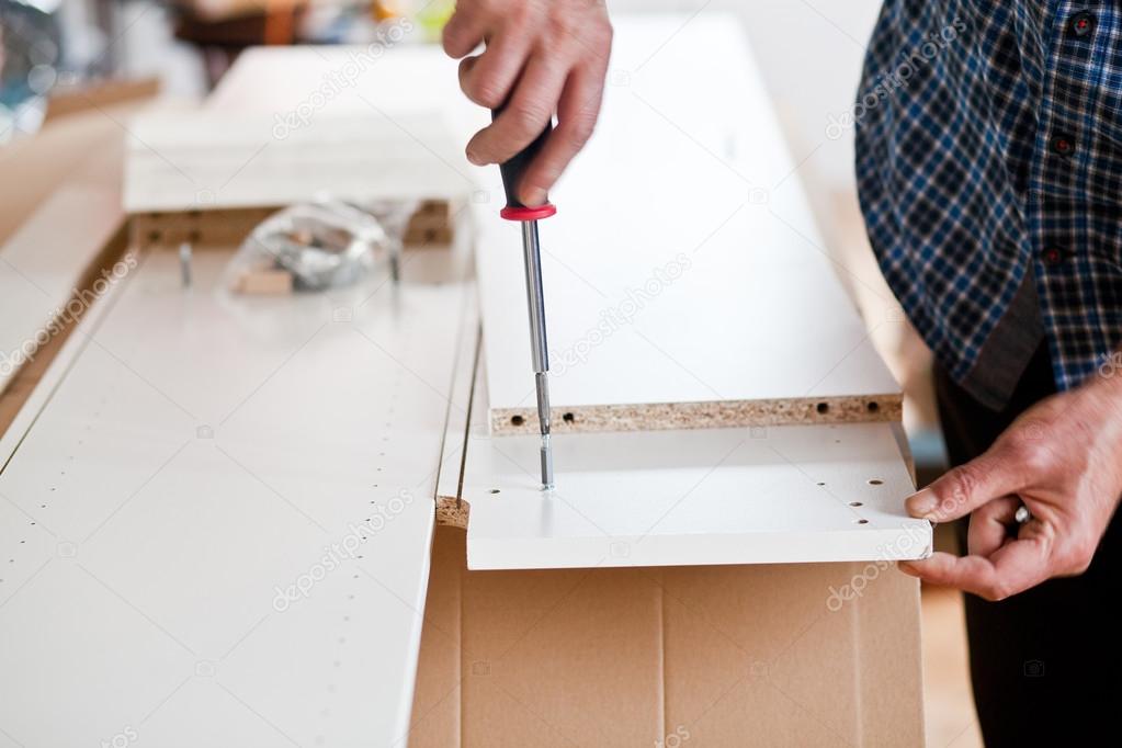 Man Assembling Flat Pack Furniture