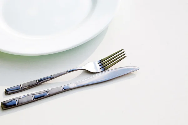 Knife, white plate and fork — Stock Photo, Image