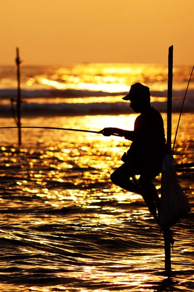 Silhouettes of the traditional stilt fishermen at sunset near Ga — Stock Photo, Image