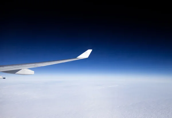 Plane wing and clouds viewed from airplane — Stock Photo, Image