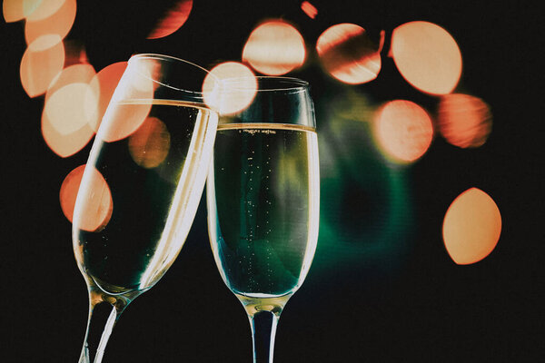 toasting with champagne glasses on sparkling holiday background - Fireworks at New Year and copy space