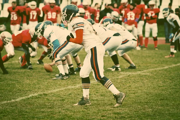 american football game with out of focus players in the backgrou