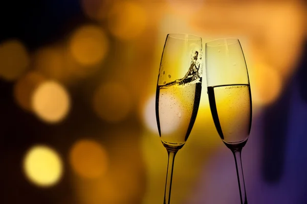 Grillas med champagneglas mot semester lampor — Stockfoto