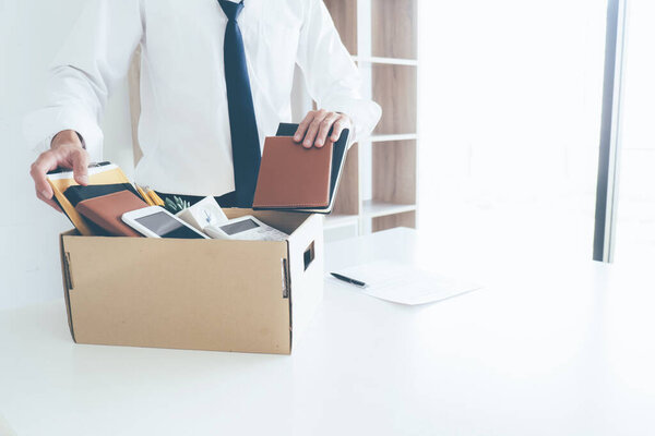 Sad dismissed businessman sitting outside the office after losing his job