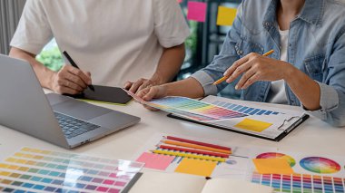Grafiksel tasarım, renk örnekleri ve kalemler bir masanın üzerinde. Çalışma araçları ve aksesuarları olan mimari çizimler.