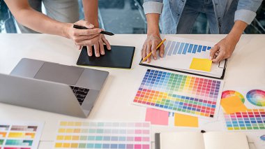 Grafiksel tasarım, renk örnekleri ve kalemler bir masanın üzerinde. Çalışma araçları ve aksesuarları olan mimari çizimler.