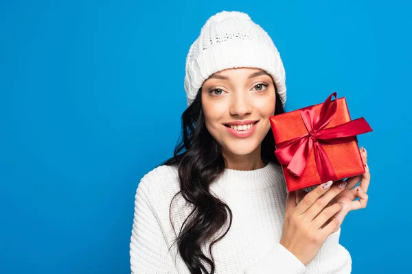 Joyful Woman Knitted Hat Holding Wrapped Present Isolated Blue — Stock Photo, Image