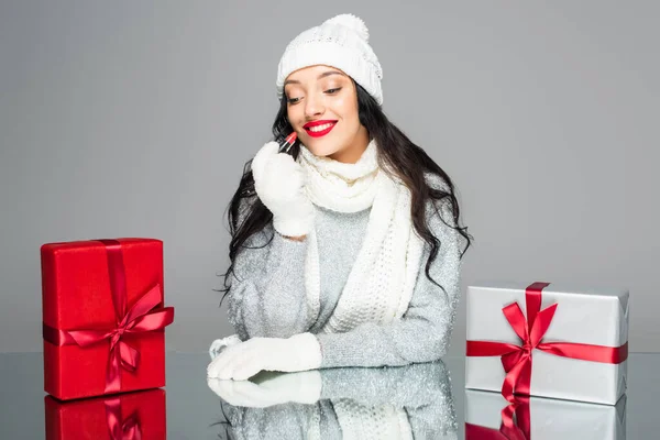 Happy Woman Winter Outfit Holding Lipstick Presents Isolated Grey — Stock Photo, Image