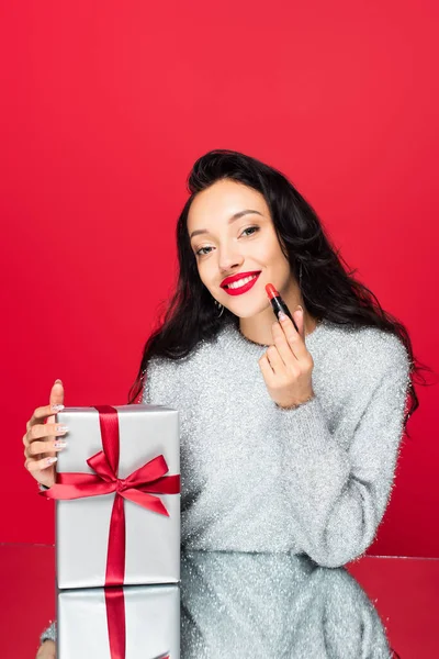 Happy Woman Sweater Holding Lipstick Wrapped Present Isolated Red — Stock Photo, Image