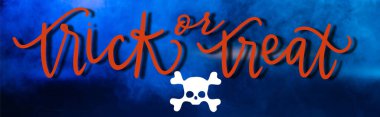 trick or treat lettering on blue dark background with smoke, banner clipart