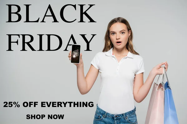 Shocked Woman Holding Smartphone Shopping Bags Black Friday Shop Now — Stock Photo, Image