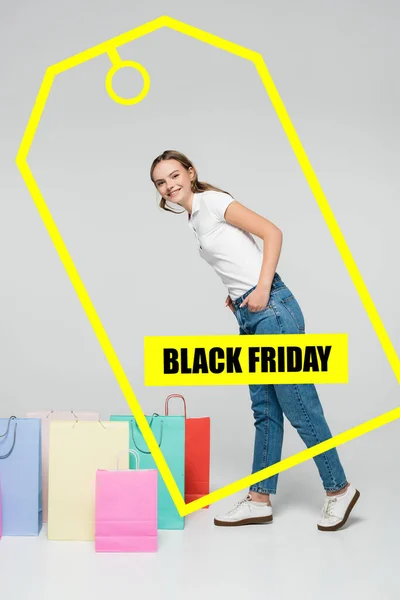 Joyful Woman Standing Hands Pockets Shopping Bags Black Friday Lettering — Stock Photo, Image