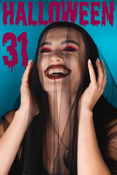 evil woman with black makeup, closed eyes and veil laughing near halloween 31 on blue