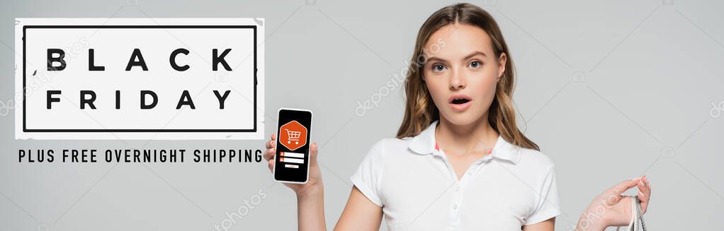 shocked woman holding smartphone near black friday lettering and illustration on grey, banner