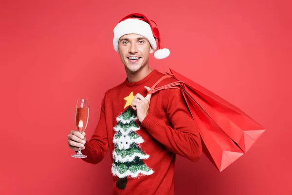 Smiling Man Santa Hat Holding Shopping Bags Glass Champagne Red — Stock Photo, Image