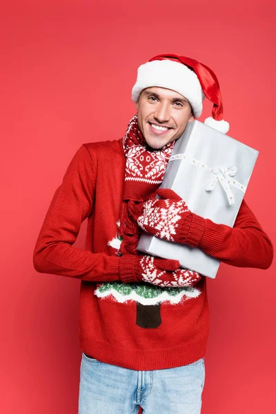 Cheerful Man Santa Hat Mittens Looking Camera While Holding Gift — Stock Photo, Image