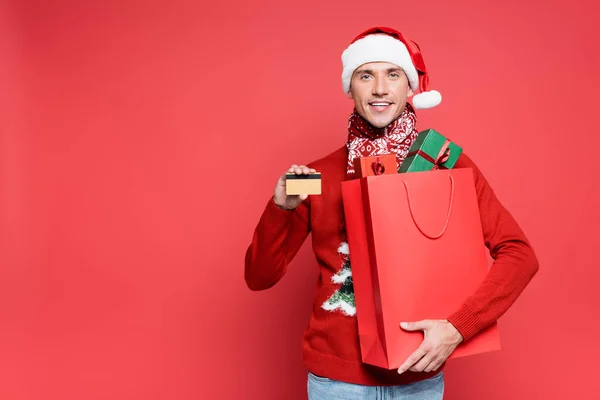 Positive Man Santa Hat Holding Shopping Bag Presents Credit Card — Stock Photo, Image