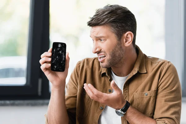 Empresário Assustado Olhando Para Smartphone Esmagado Fundo Embaçado — Fotografia de Stock