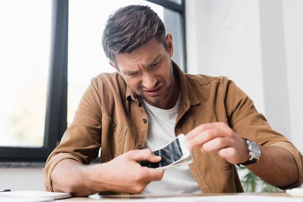 Irritated Businessman Smartphone Removing Damaged Touchscreen Blurred Window Background — Stock Photo, Image