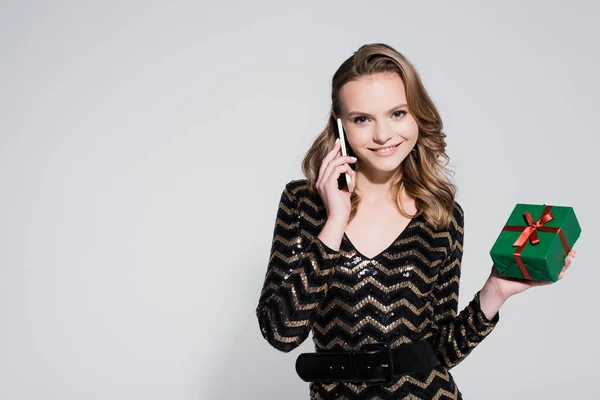 Happy Young Woman Holding Christmas Present Talking Smartphone Grey — Stock Photo, Image