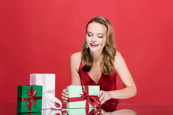 Excited Young Woman Smiling Christmas Presents Red — Stock Photo, Image