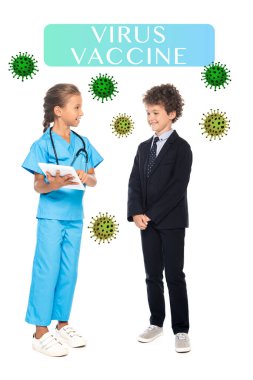child in costume of doctor holding digital tablet near curly boy in formal wear and virus vaccine lettering on white  clipart