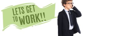 curly boy in suit and glasses talking on smartphone near lets get to work lettering on white, banner clipart