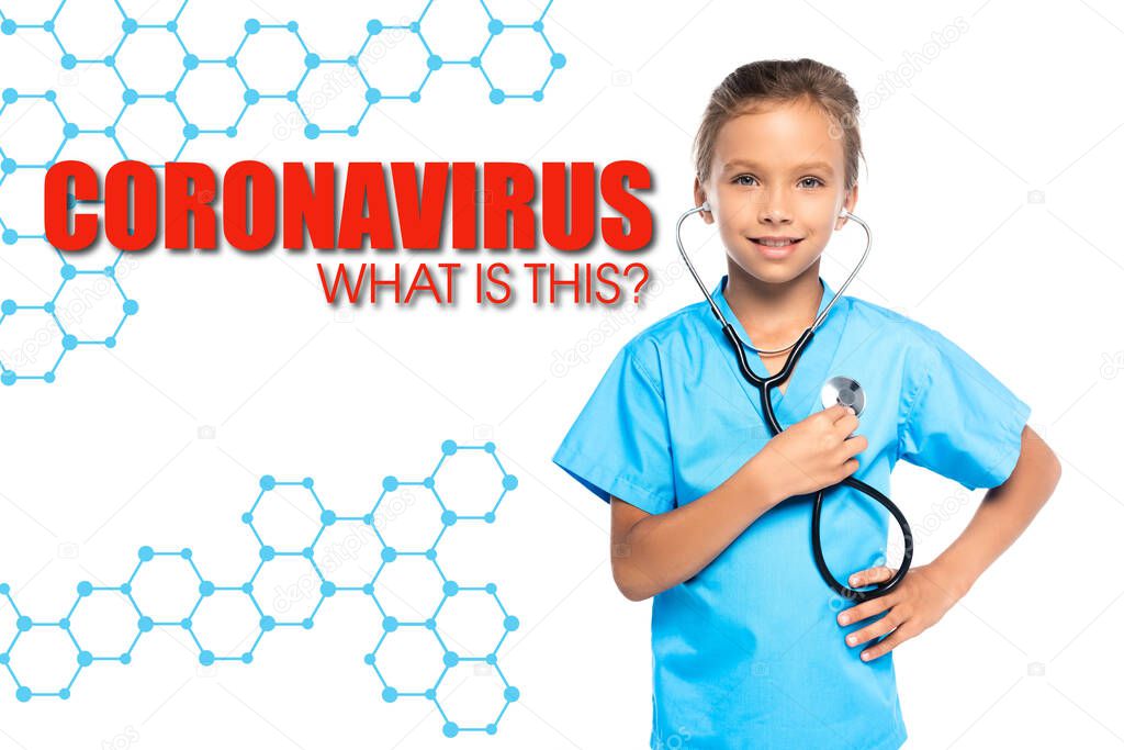 child in costume of doctor holding stethoscope while standing with hand on hip near coronavirus what is this lettering on white 