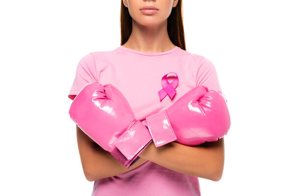 Cropped view of young woman with breast cancer awareness ribbon and boxing gloves isolated on white