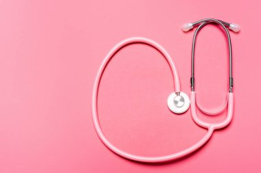 Top view of stethoscope on pink background, concept of breast cancer awareness  clipart