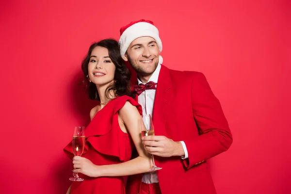 Smiling Man Santa Hat Holding Glass Champagne Girlfriend Red Background — Stock Photo, Image