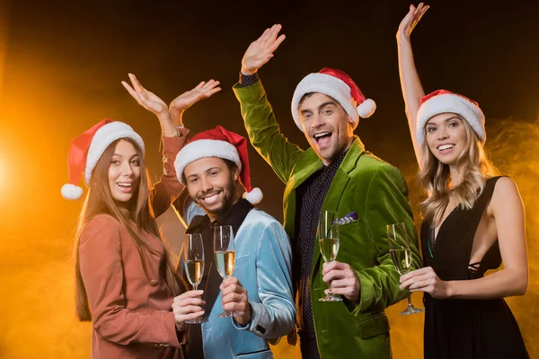 Cheerful Multicultural Friends Santa Hats Holding Glasses Champagne Black — Stock Photo, Image