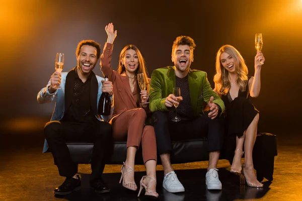 Full Length Happy Interracial Friends Holding Glasses Champagne While Sitting — Stock Photo, Image