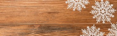 top view of winter snowflakes on wooden background, banner clipart