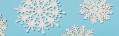 top view of winter snowflakes on blue background, banner clipart
