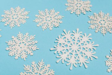 top view of winter snowflakes on blue background clipart