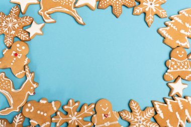 top view of winter gingerbread cookies on blue background clipart